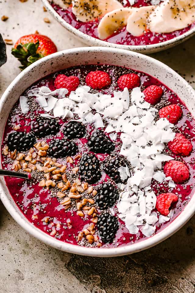 Acai smoothie bowl topped with fruits.