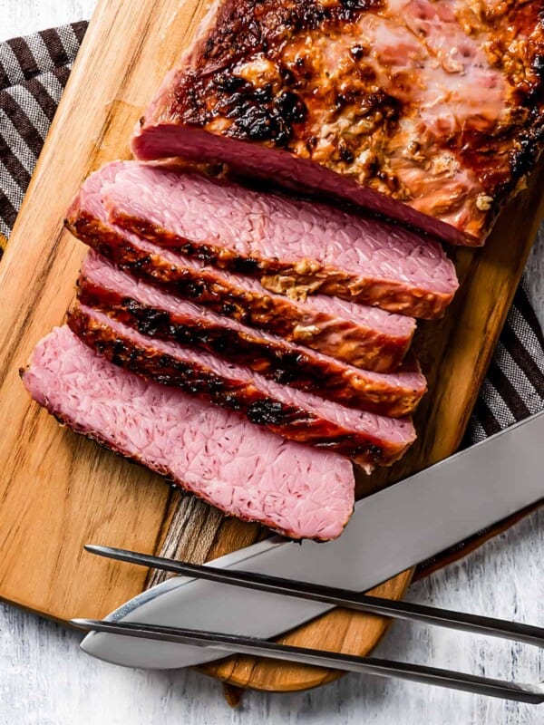 Sliced corned beef on a cutting board.