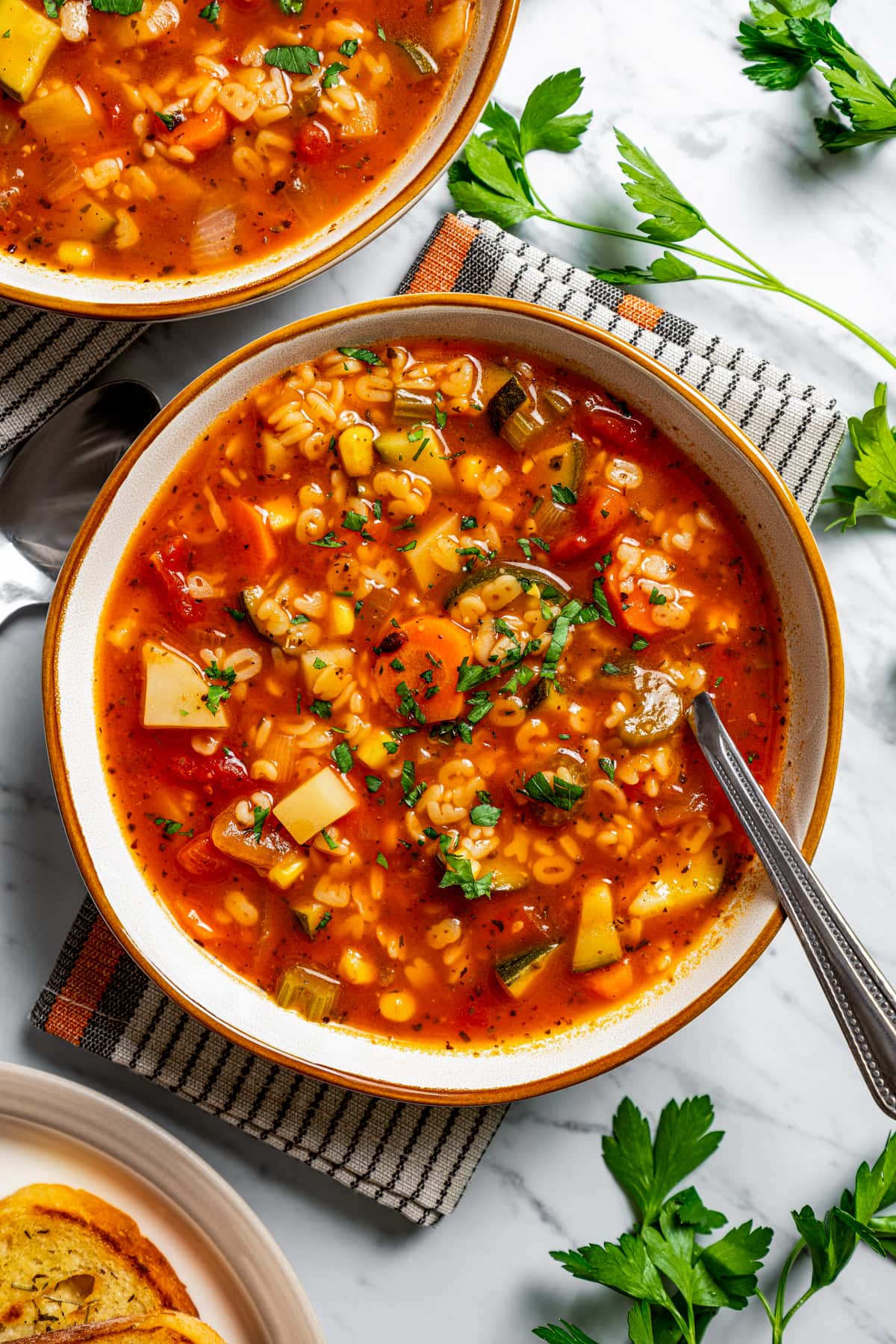 Overhead image of two bowls of alphabet soup.