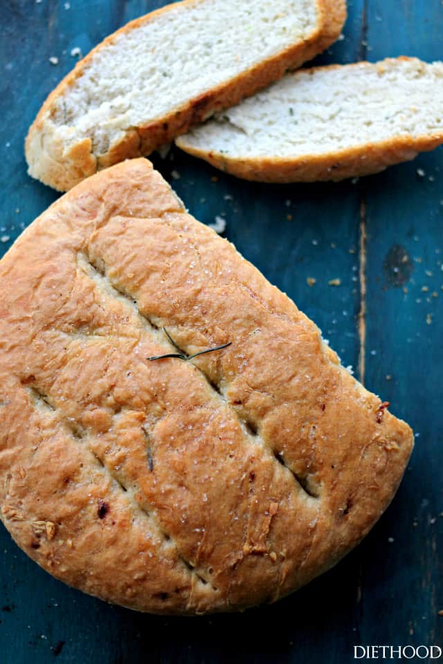 A loaf of skillet bread with slices cut from it.