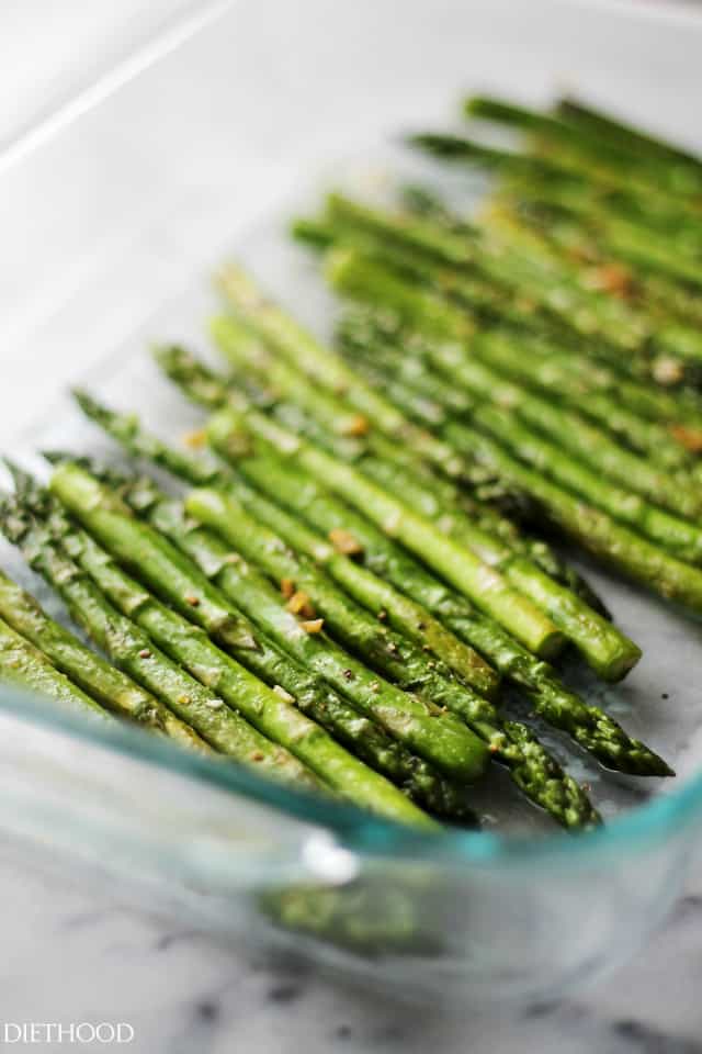 Sauteed asparagus and garlic in a baking dish.