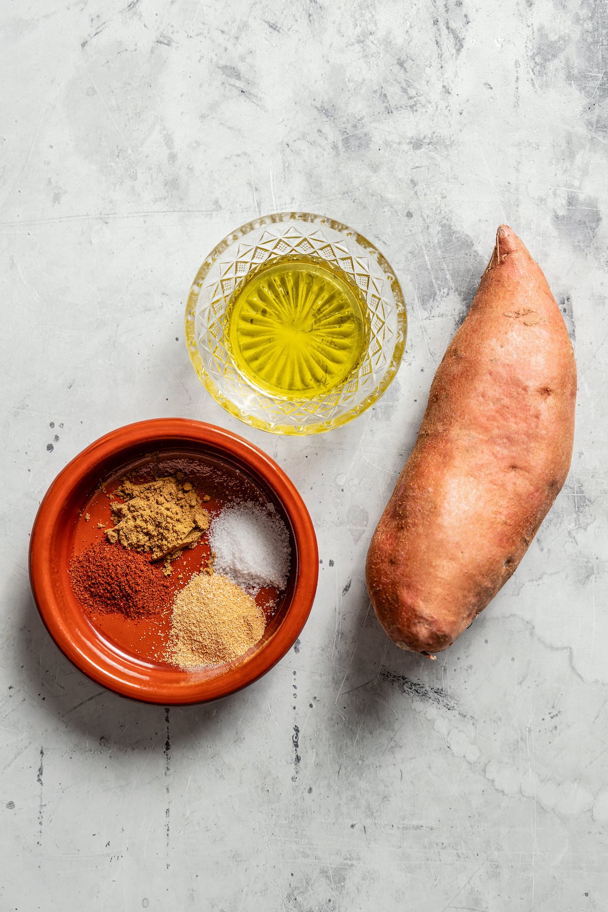 Ingredients for smoky cumin roasted sweet potato cubes.