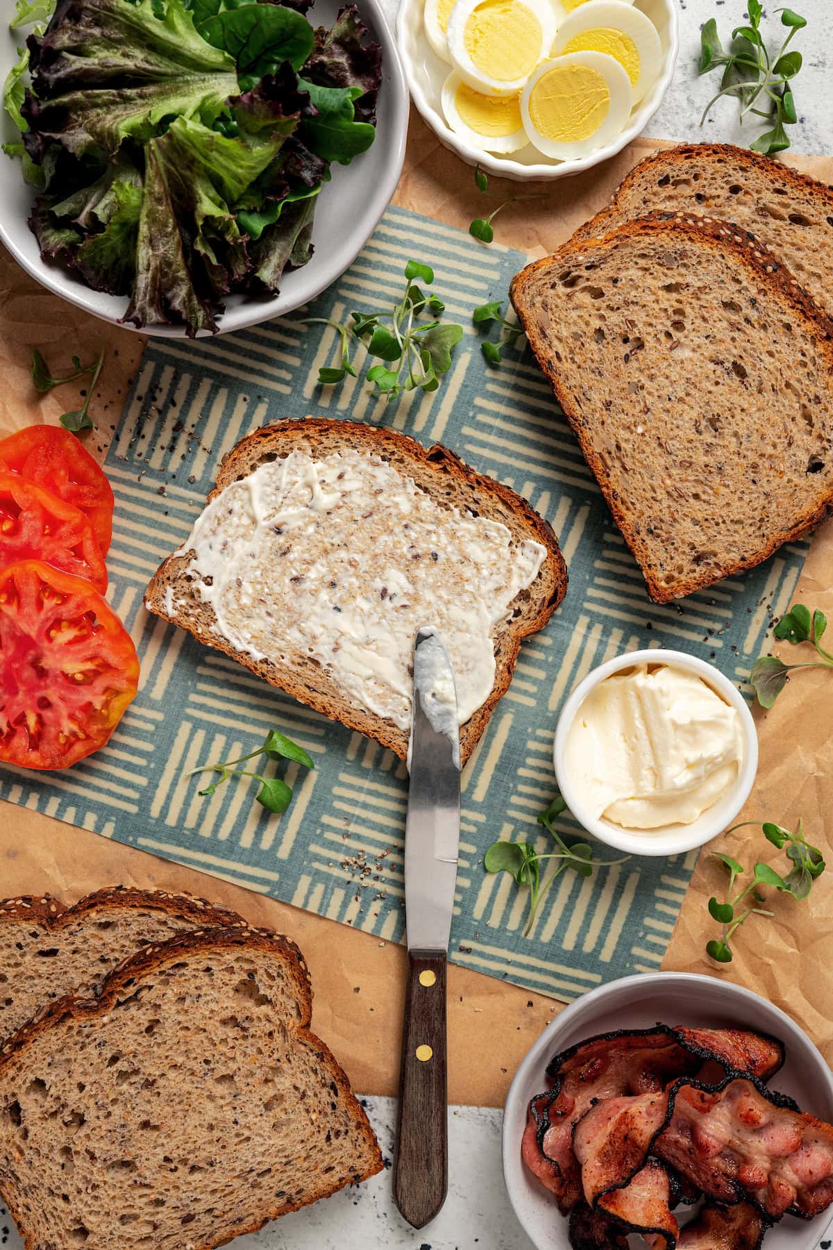 Spreading mayo on a slice of bread.