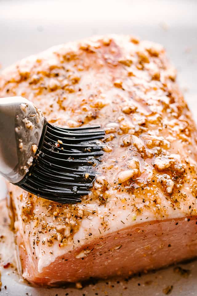 Garlic balsamic glaze is brushed over pork loin.