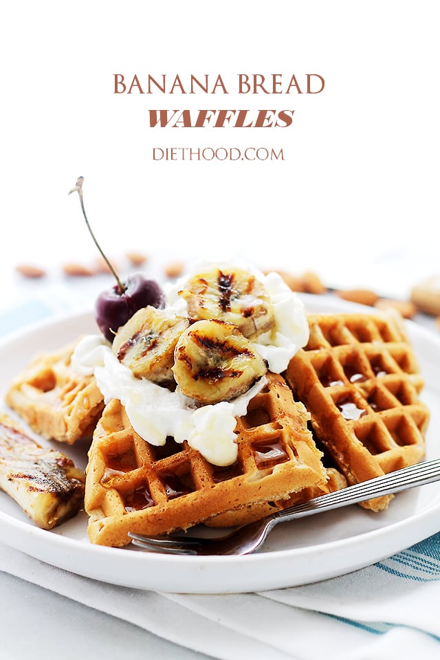 A stack of banana bread waffles topped with whipped cream and grilled banana slices on a white plate.