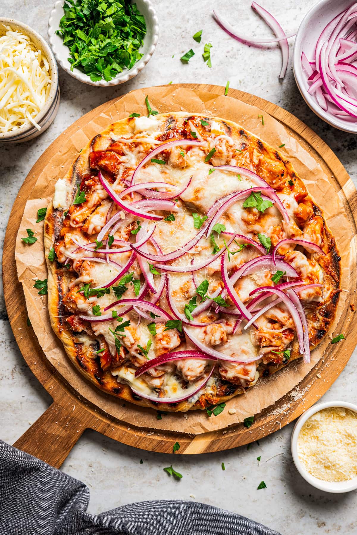 Grilled pizza on a wooden board.