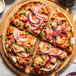 BBQ Pizza cut up into 4 slices and arranged on a serving board.