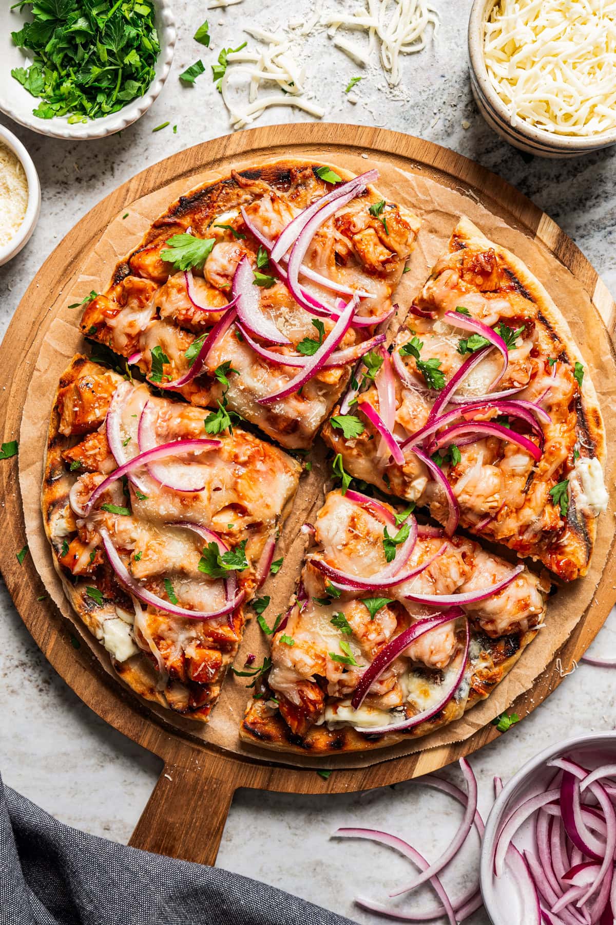 BBQ Pizza cut up into 4 slices and arranged on a serving board.