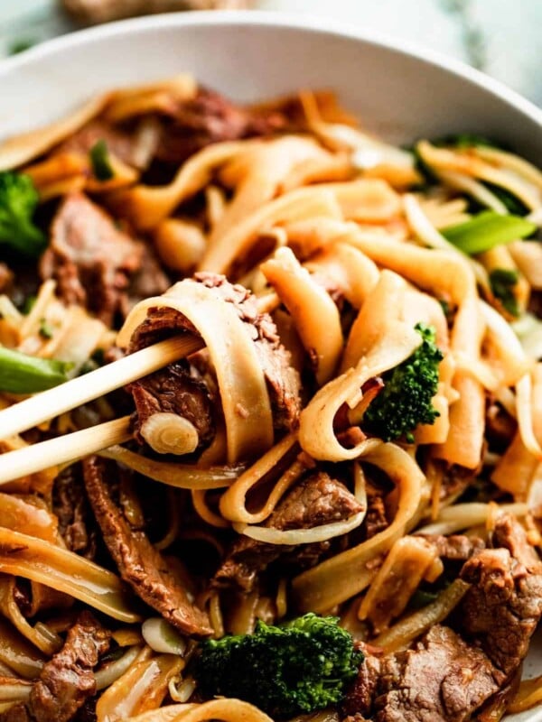 overhead shot of chopsticks rotating beef chow fun.