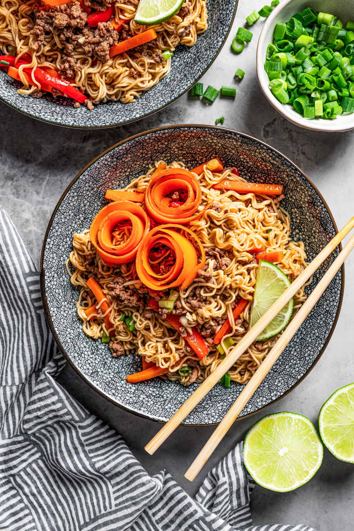 Ramen noodles with beef served in bowls, with a pair of chopsticks resting on the edge of the bowl.