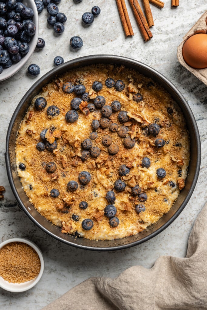 Sprinkling the turbinado sugar, cinnamon, and remaining blueberries on top. 