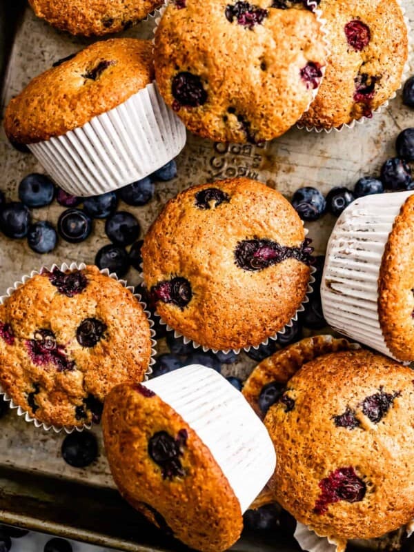 Overhead of blueberry lemon muffins piled on top of one another.