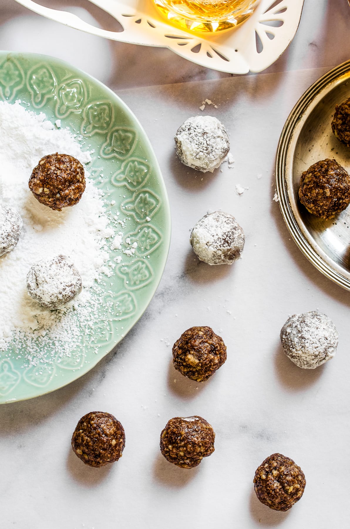 Rolling bourbon ball in powdered sugar.