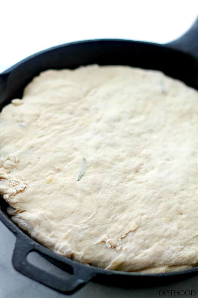 Rosemary garlic bread dough in a skillet.