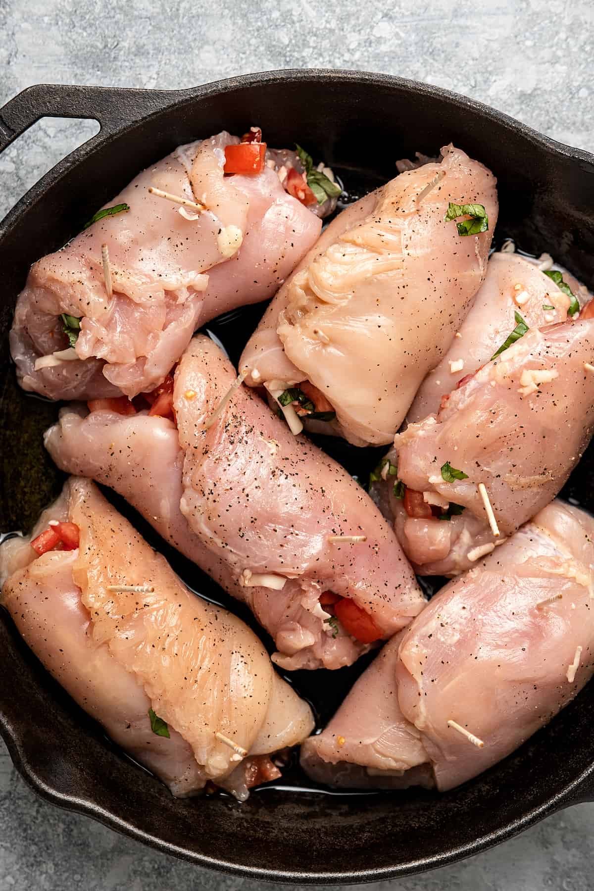 Raw stuffed chicken in a skillet.