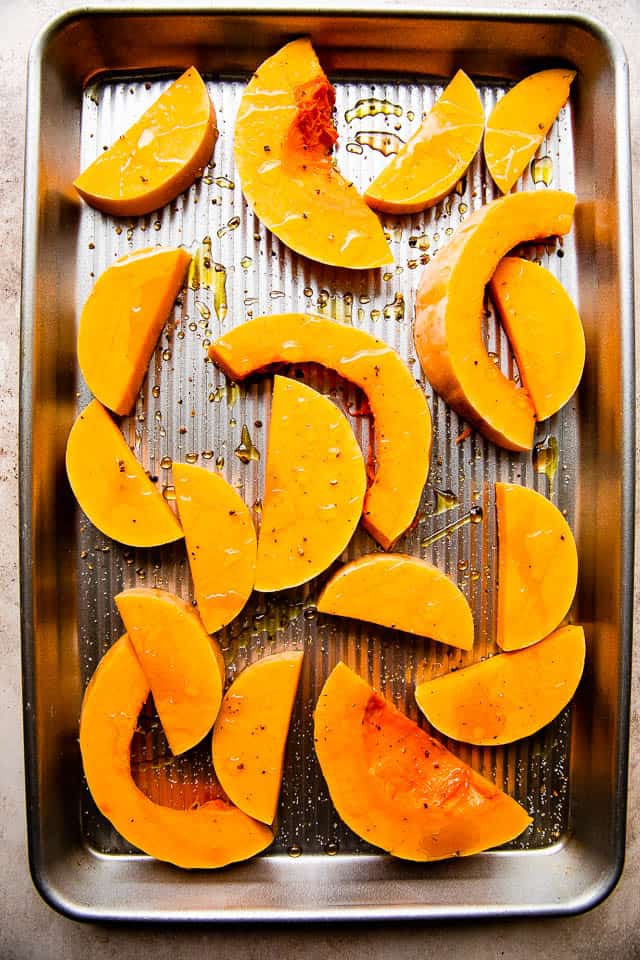 baking sheet with thick slices of butternut squash