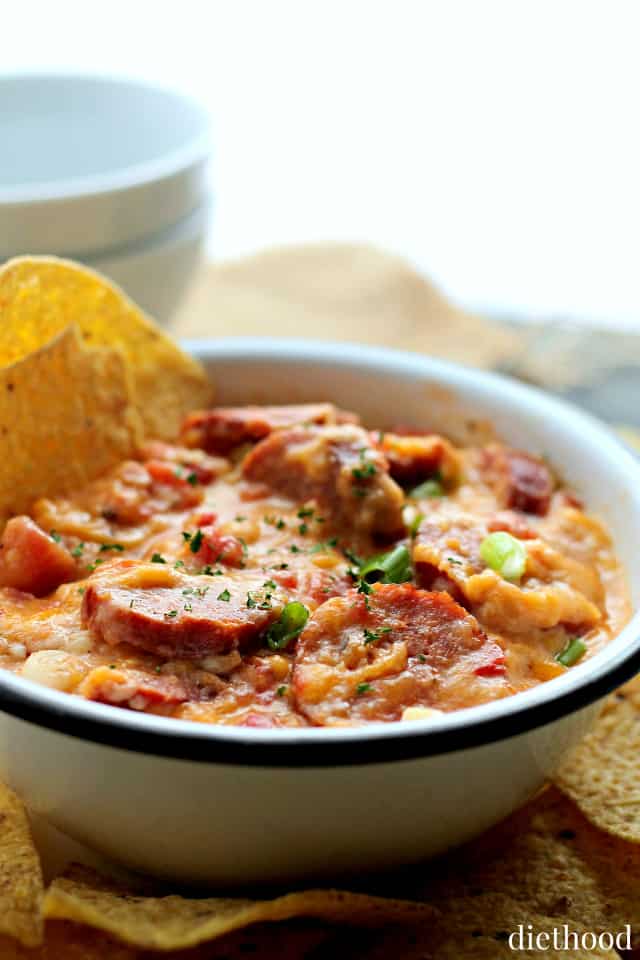 Close-up of the cheese dip with smoked sausage and tomatoes. 