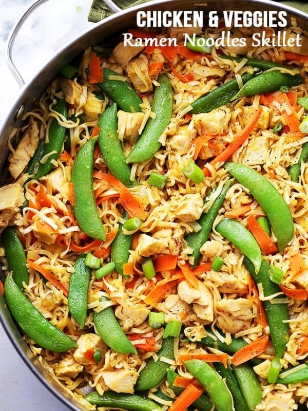 Chicken ramen noodles with snap peas and carrots in the skillet.