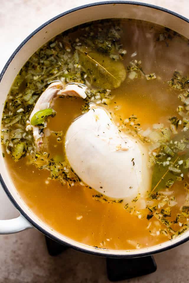 bone-in chicken cooking in chicken broth