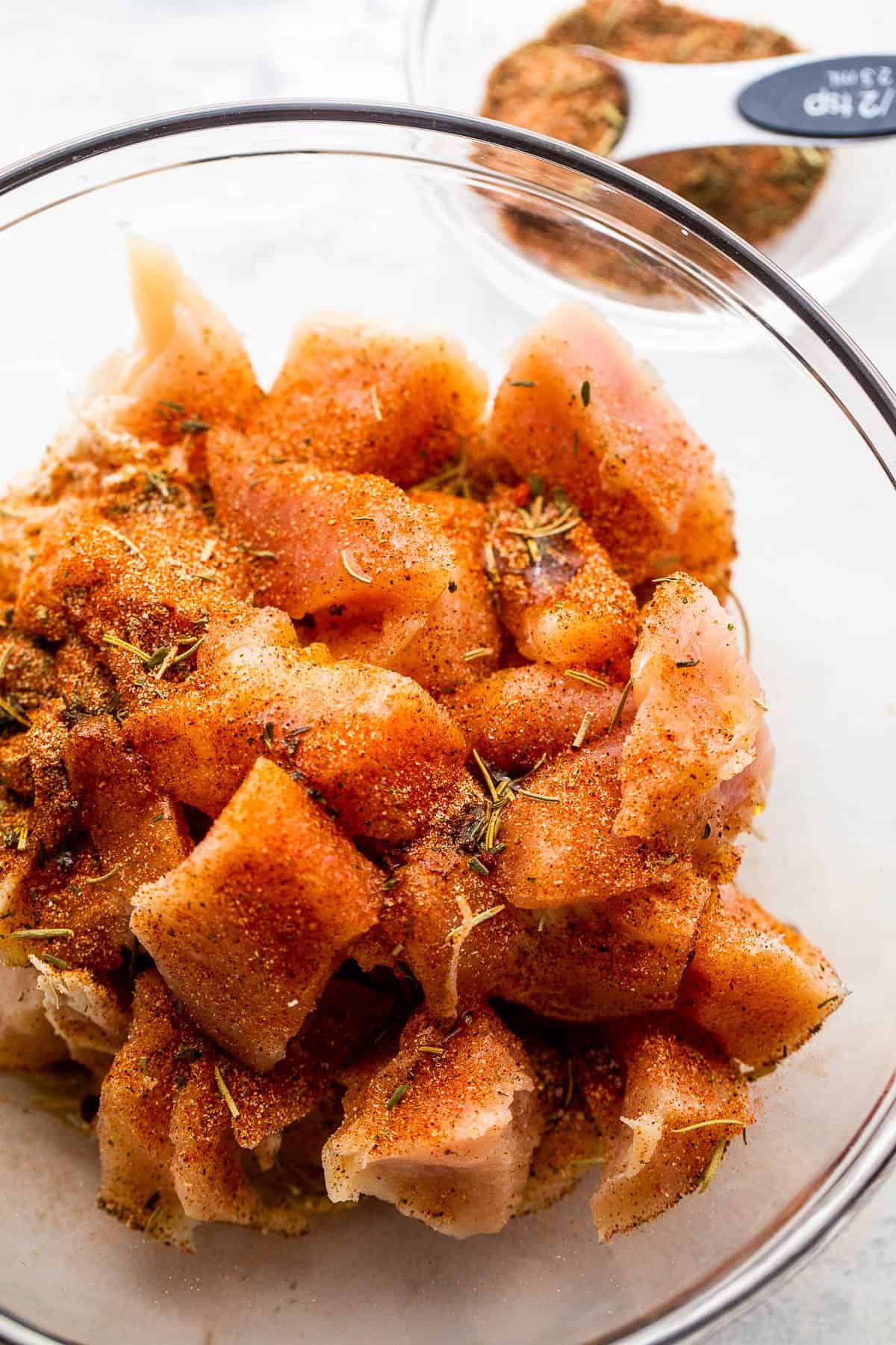 diced chicken breast pieces in a glass mixing bowl