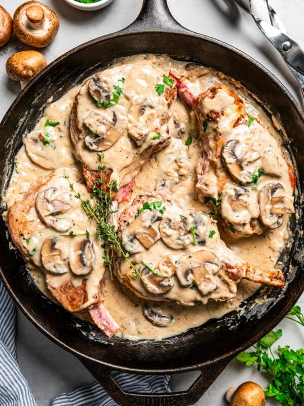 Cream of mushroom pork chops in a cast iron skillet.