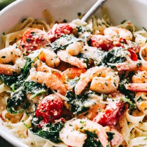 Creamy Shrimp Fettuccine with Spinach and Tomatoes Recipe - For a quick and delicious weeknight dinner, whip up this shrimp fettuccine coated in a light and creamy sauce prepared with spinach and cherry tomatoes! 