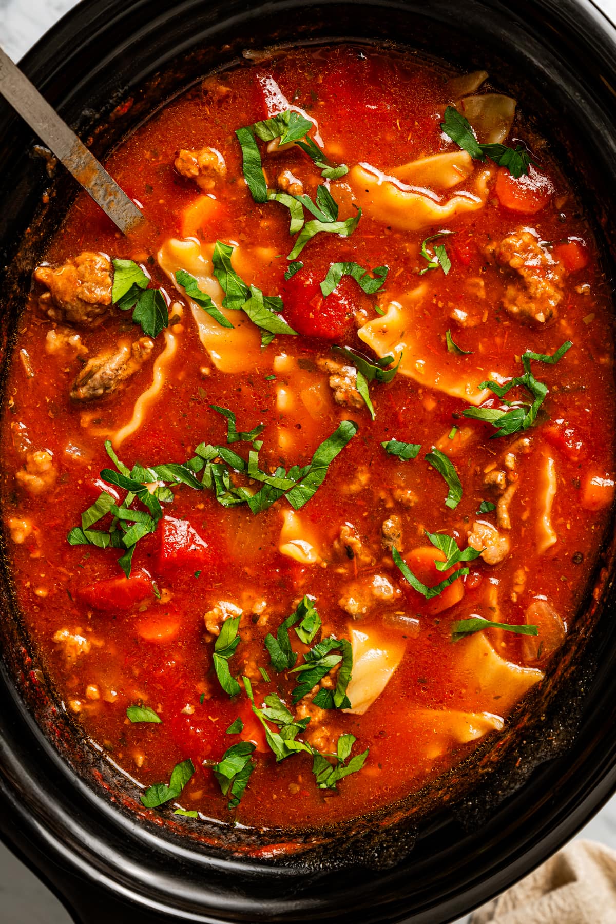 Closeup of lasagna soup in a crockpot.