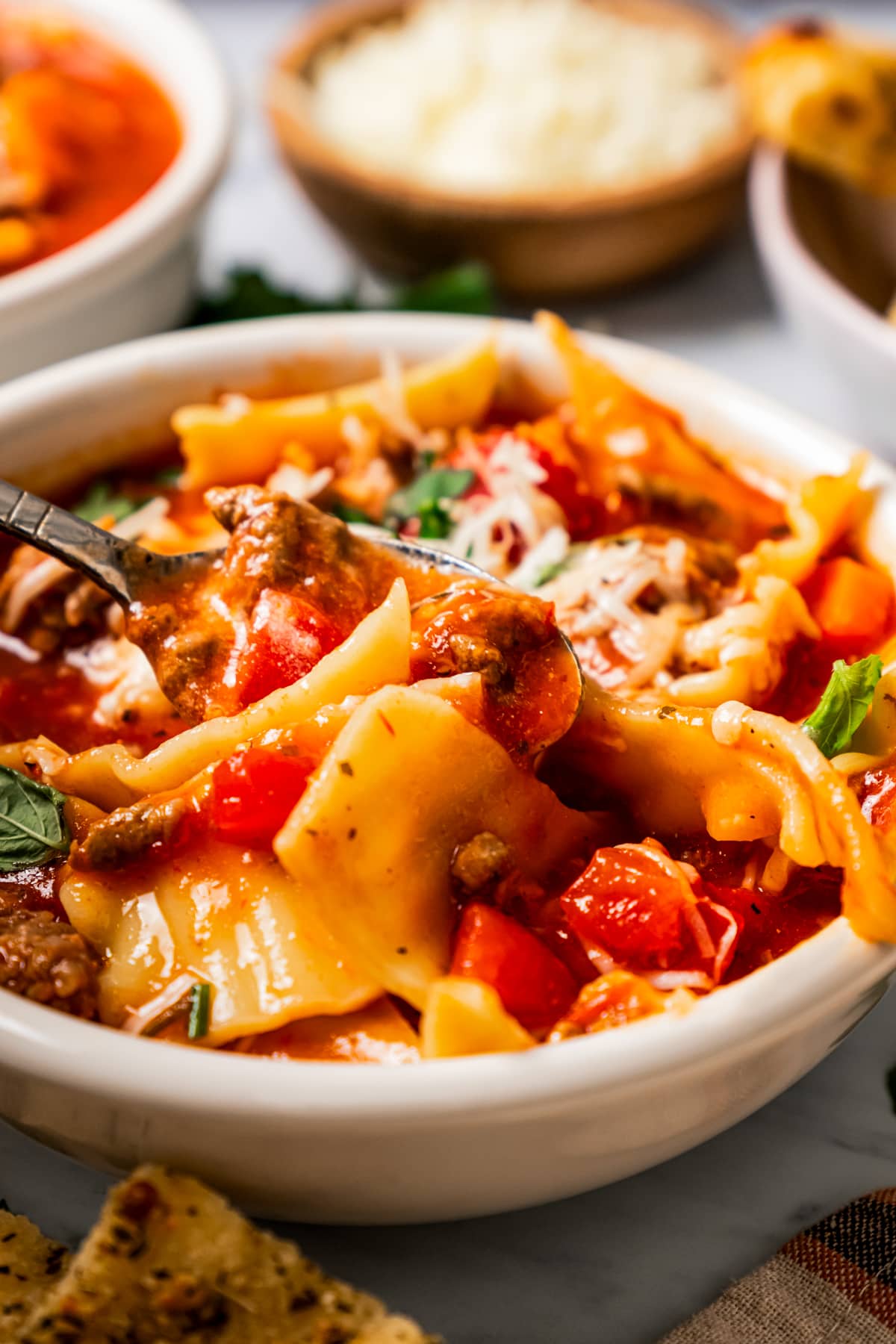 A bowl of soup with lasagna noodles.