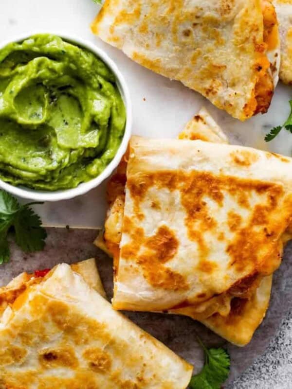 breakfast quesadillas with red pepper and cilantro served with guacamole