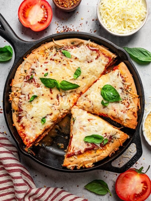 Overhead image of a deep dish pizza in a skillet.