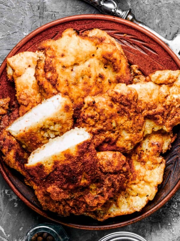 overhead shot of a dinner plate filled with slices of pork schnitzel.