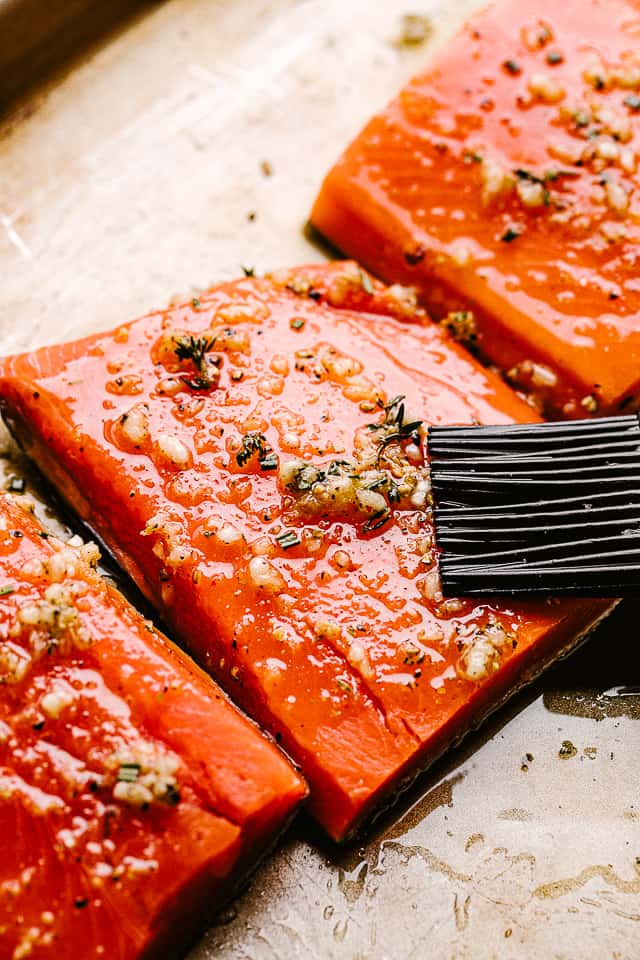 Prepping pieces of raw salmon for cooking.