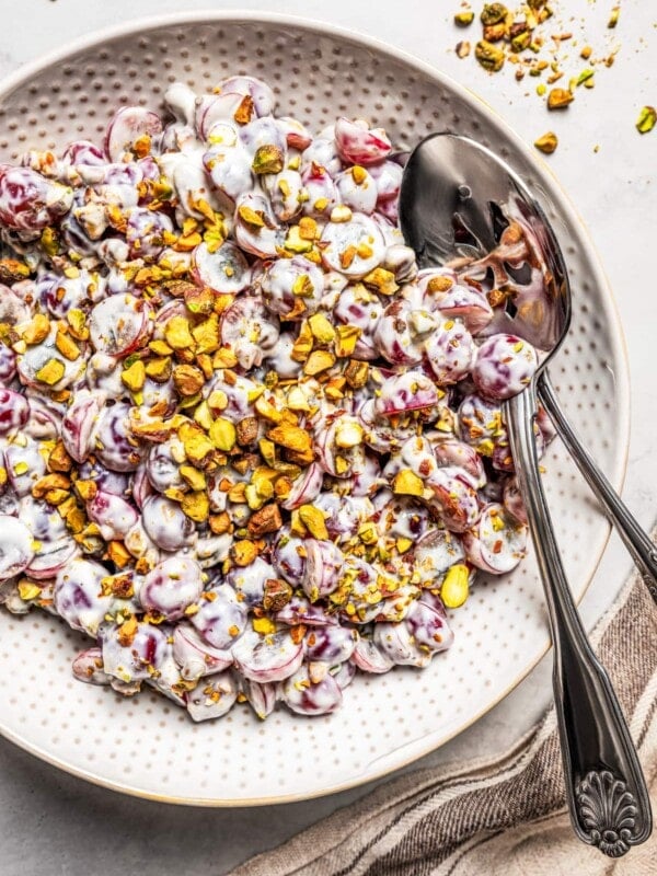 Overhead image of grape salad in a bowl with a serving spoon.