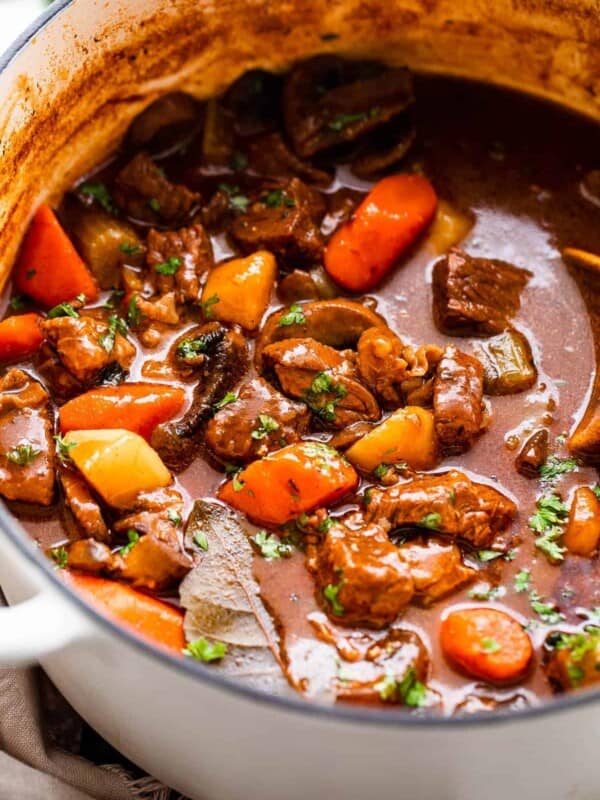 side shot of guinness beef stew studded with chunks of beef and vegetables.