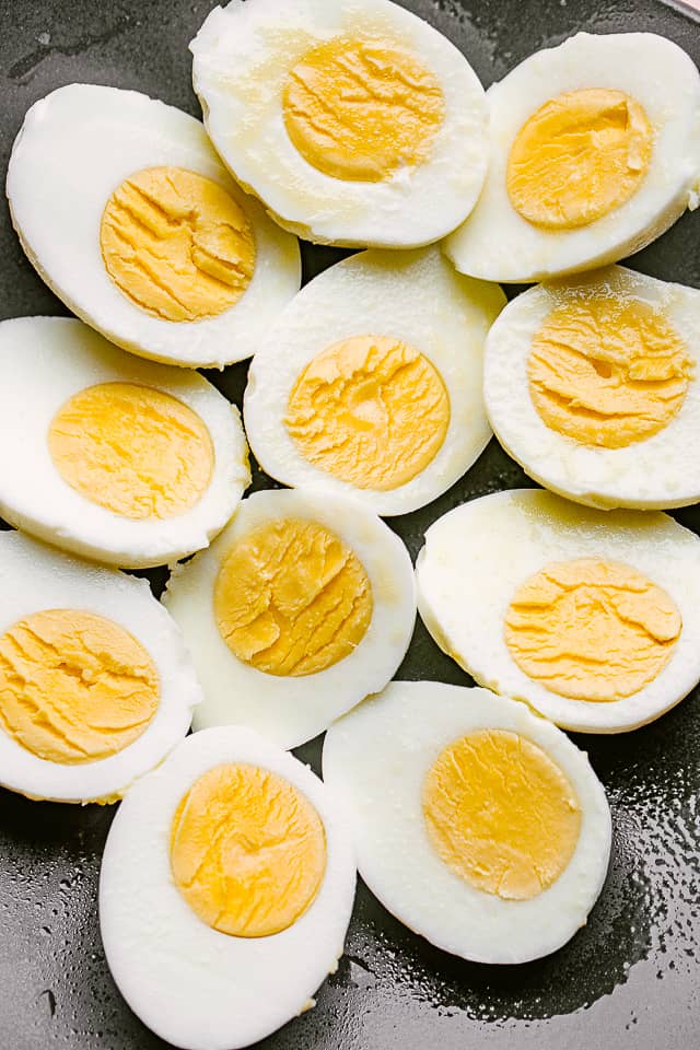 Plate of hard boiled eggs cut in half, with the yolks exposed.