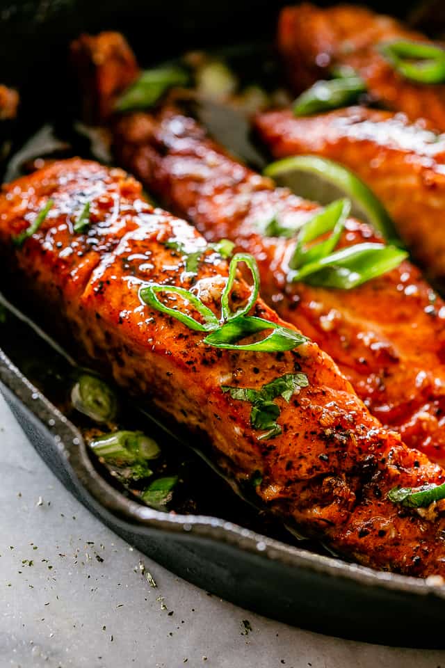 Salmon in a cast iron skillet.