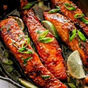 Pan seared salmon fillets in a cast iron skillet.