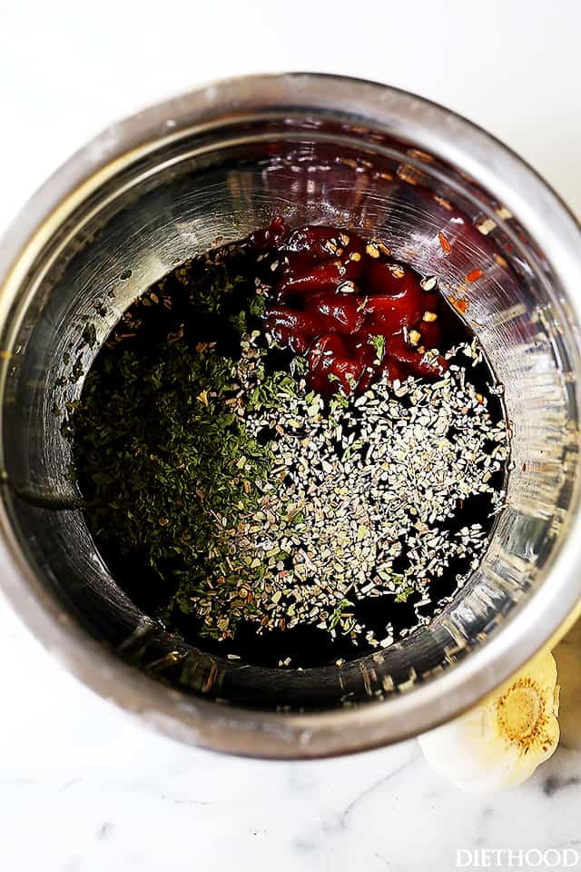 Overhead shot of a metal mixing bowl with ketchup, soy sauce, and other ingredients inside.