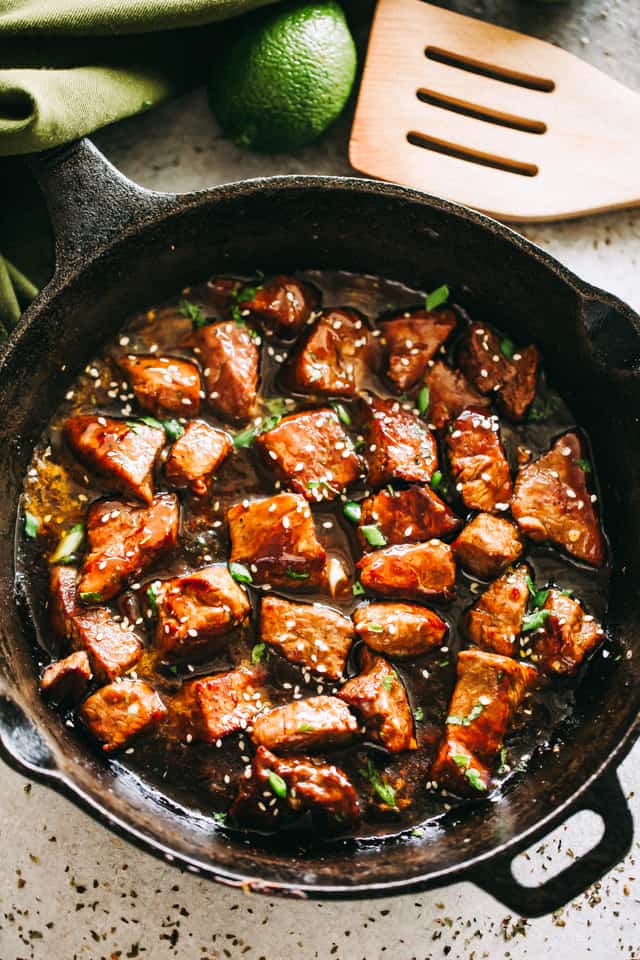 Steak Bites cooking in a cast iron skillet.