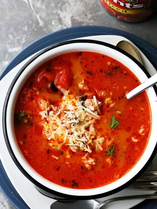 A Large Bowl of Taco Soup Garnished with Shredded Mozzarella Cheese on a Countertop