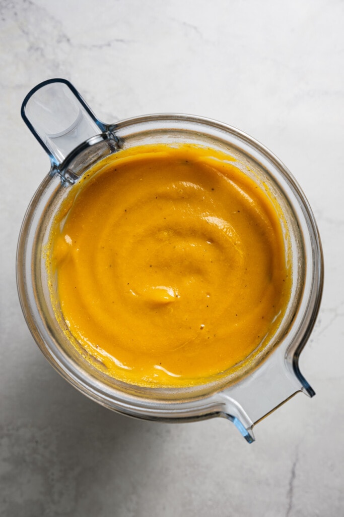 Butternut squash soup blended in a blender.