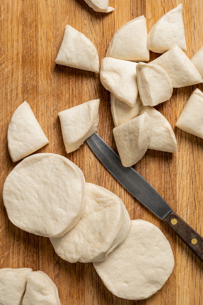 Cutting biscuits into quarters.