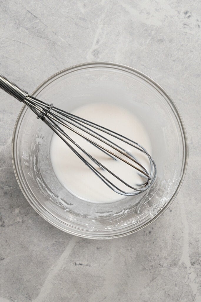 Whisking together cornstarch and water.