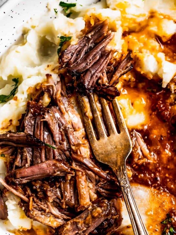 Pulled-apart instant pot short ribs on a fork.