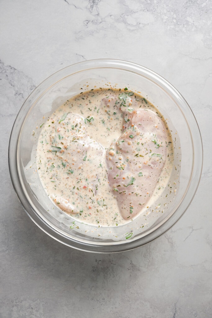 Marinading chicken breasts in Italian dressing marinade.