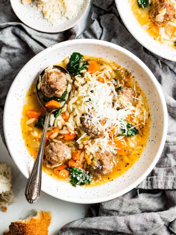 Bowl of Italian wedding soup with parmesan.