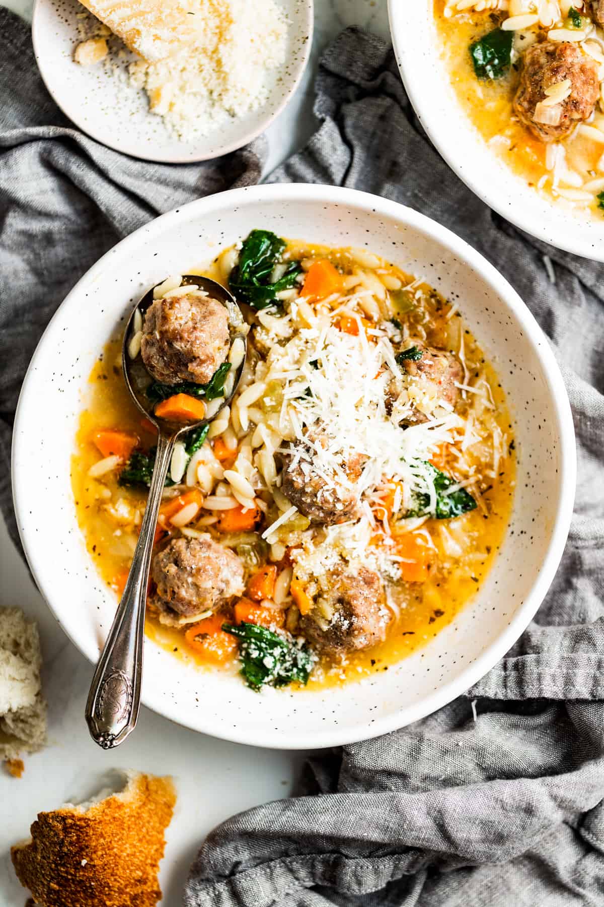 Bowl of Italian wedding soup with parmesan.