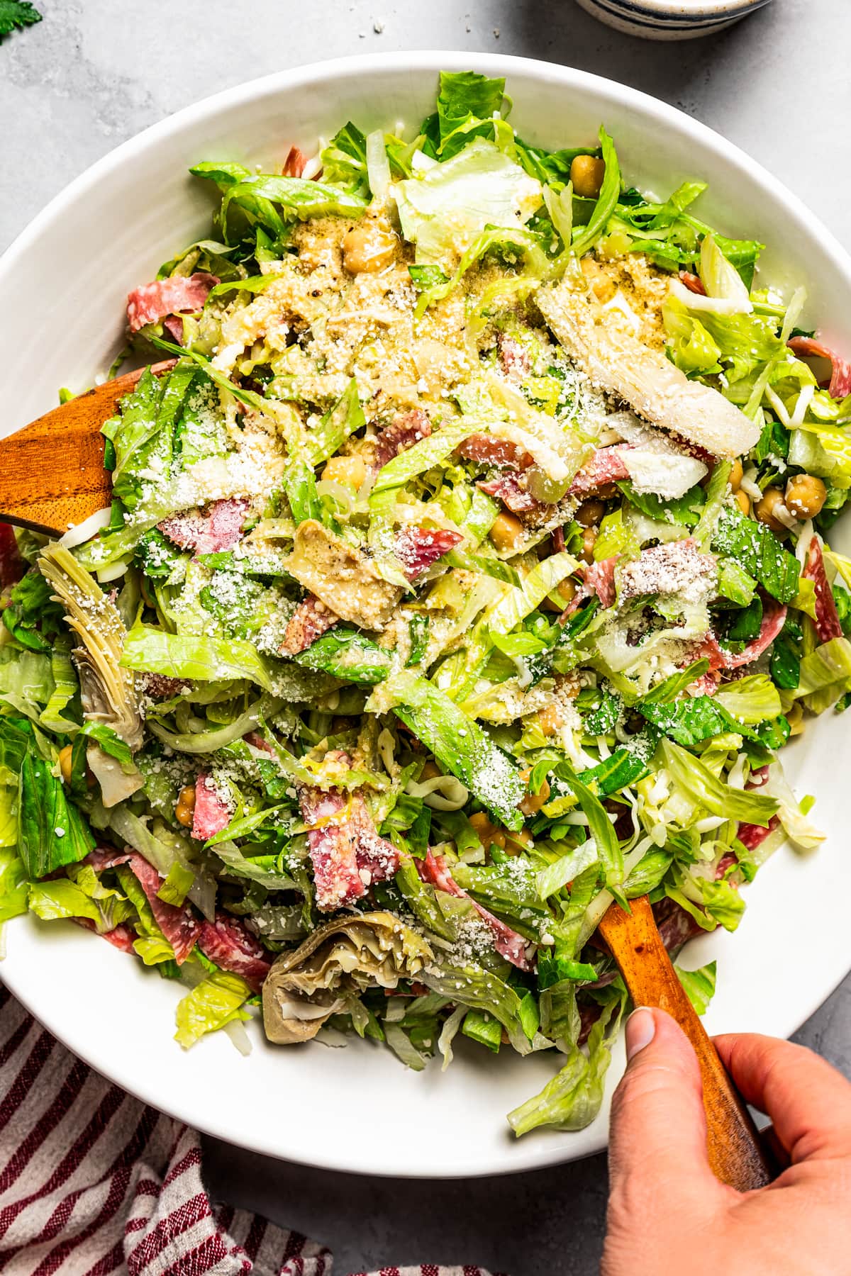 La Scala chopped salad in a large serving bowl with two wooden salad scoops.