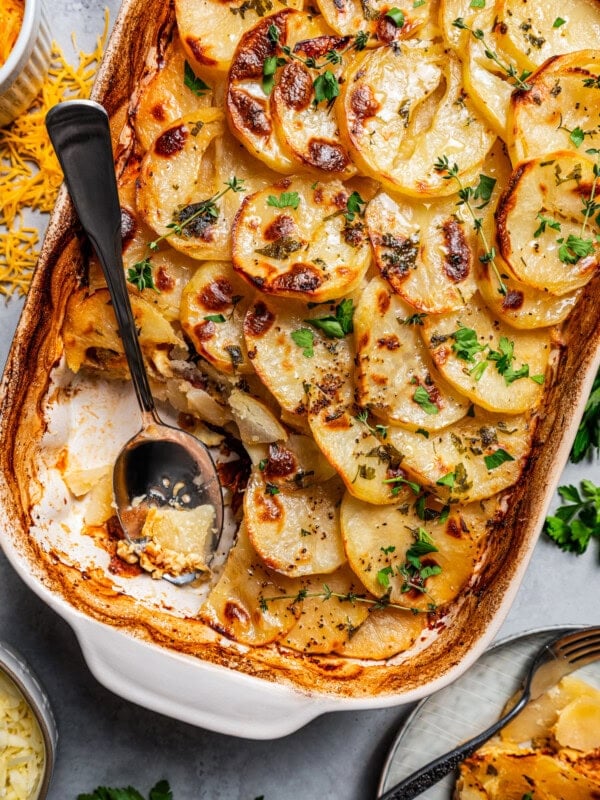 Digging into the cheesy casserole with a spoon.