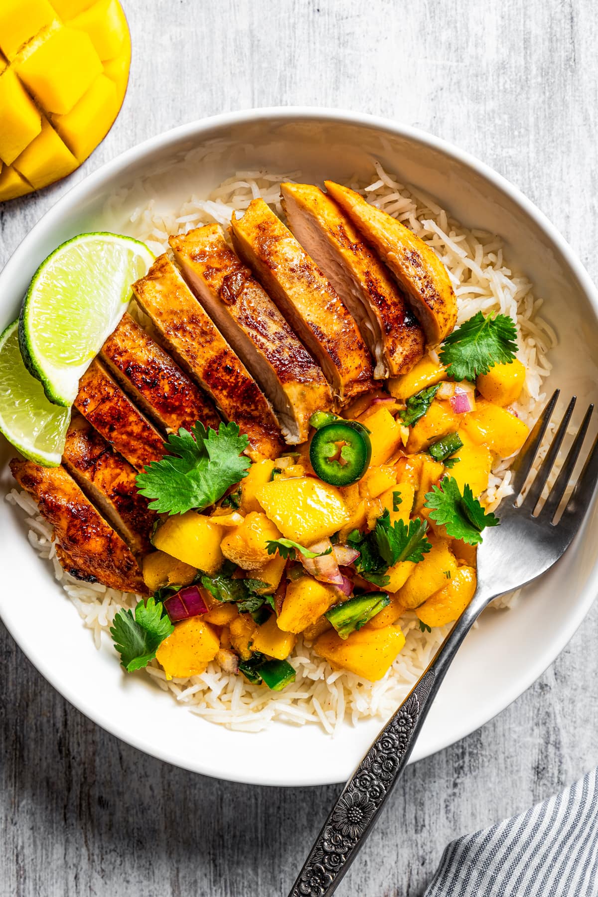 Overhead image of Mango chicken served in a bowl over rice.